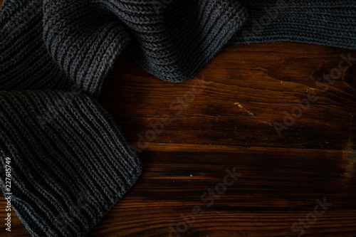 Knitted scarf on wooden background