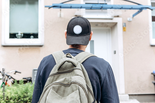 A tourist goes to the guesthouse or hostel in order to stay in a room that he booked or a student with a backpack returns home after his studies at the institute or on vacation. photo