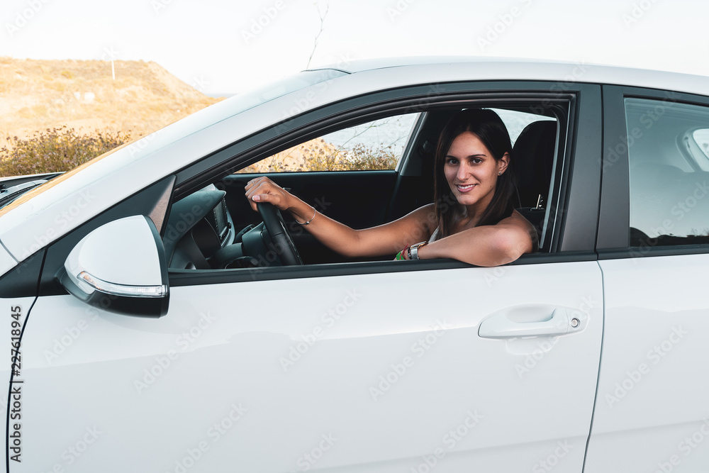Young woman in a white car Young woman in a white car