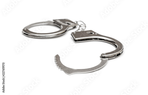 Opened handcuffs on white background.
