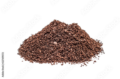 Heap of ground coffee on white.