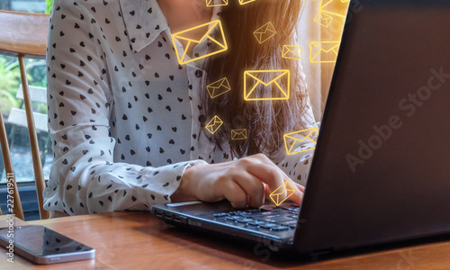 Business woman use tablet with email icons in work space.