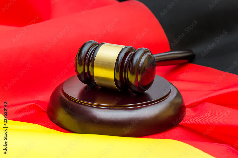 Judge's gavel with stand on German flag.