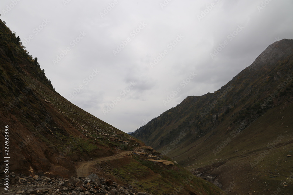 Amazing view of big mountains under dark clouds Amazing view of big mountains under dark clouds