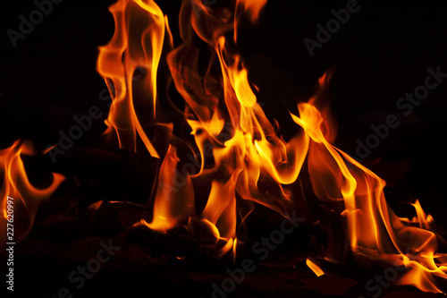 fire with sparks on a black background with elements of firewood coal and baked bricks.