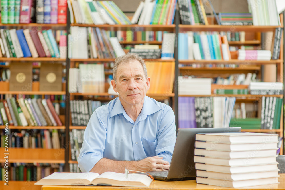 portrait of an elderly man in a library portrait of an elderly man in a library