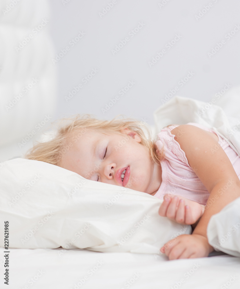 little baby girl sleeping on a bed. Space for text little baby girl sleeping on a bed. Space for text