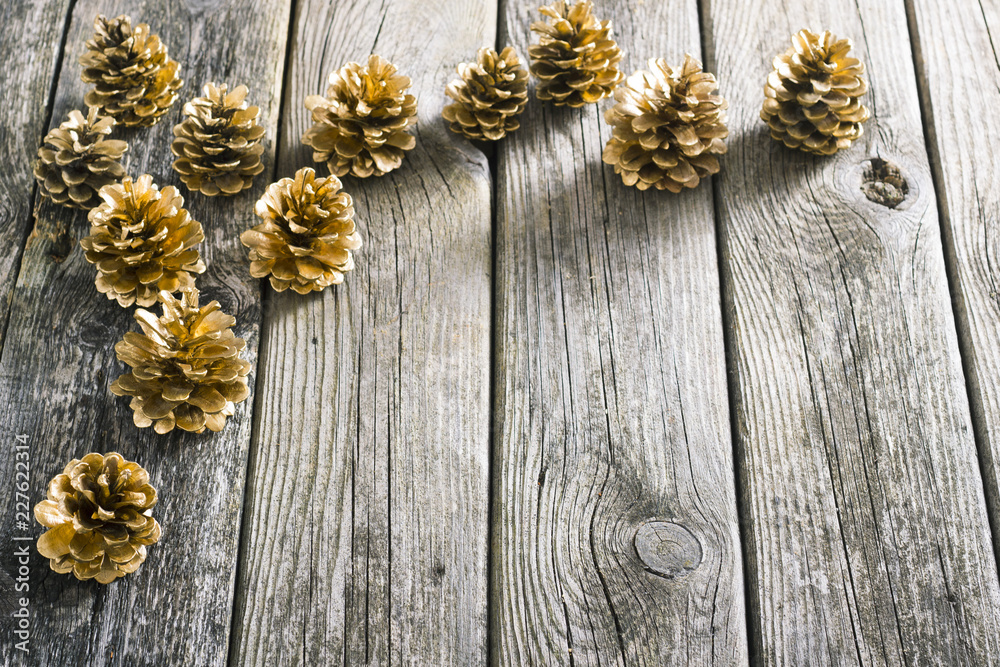golden pine cones Christmas decoration on old wood table background golden pine cones Christmas decoration on old wood table background