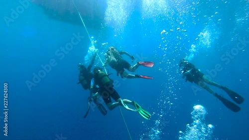 Group of scuba divers ascending on anchor line in Kas, Turkey
