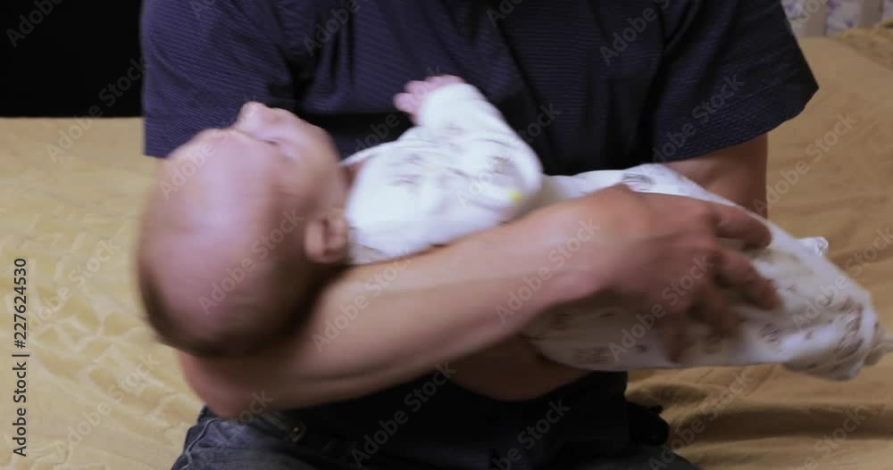 Baby on father's hands