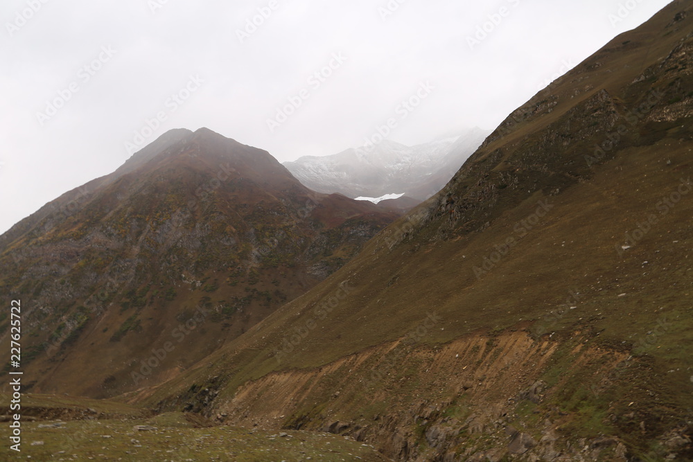 The beautiful scene of two mountains with clouds The beautiful scene of two mountains with clouds