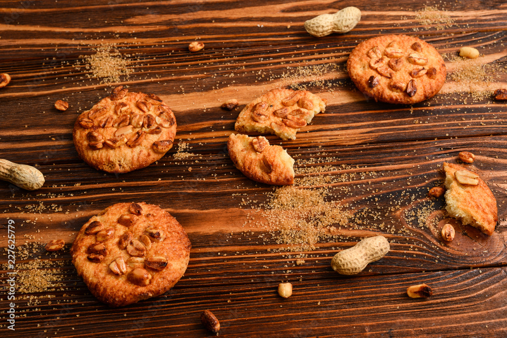 Peanut cookies on wooden table with sugar.