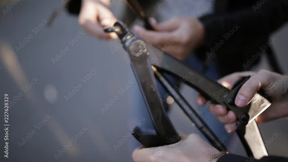 Two women at the roadside trying to change a tire from your car with a Jack, clouse up. Two women at the roadside trying to change a tire from your car with a Jack, clouse up.