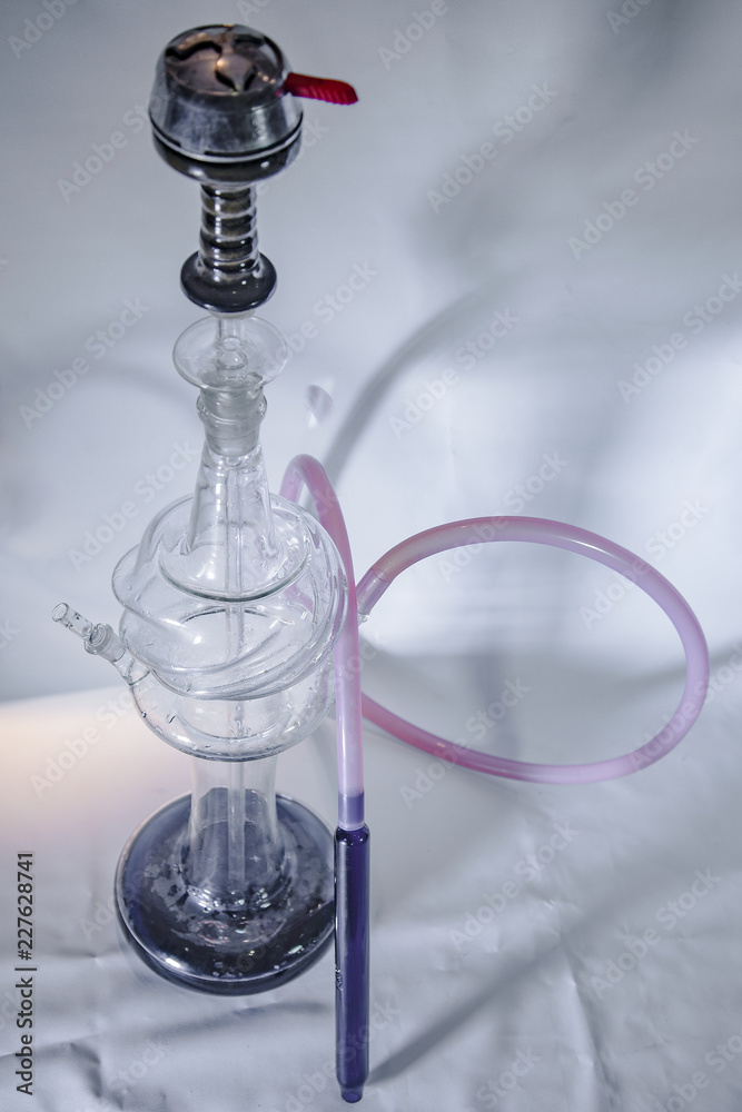 New Glass Hookah with beautiful backlight in the cafe. New Glass Hookah with beautiful backlight in the cafe.