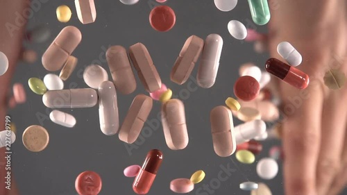 Pharmaceutical industry drugs pills vitamins slow motion photo