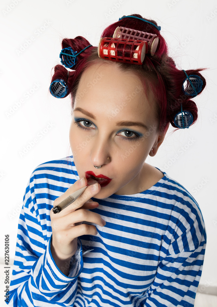 funy housewife with curlers smokes a cigarette. smoking break for sexy  lady. Stock Photo | Adobe Stock
