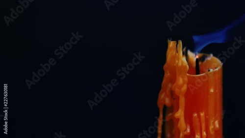 yellow candle burning and blow out on dark background with smoke