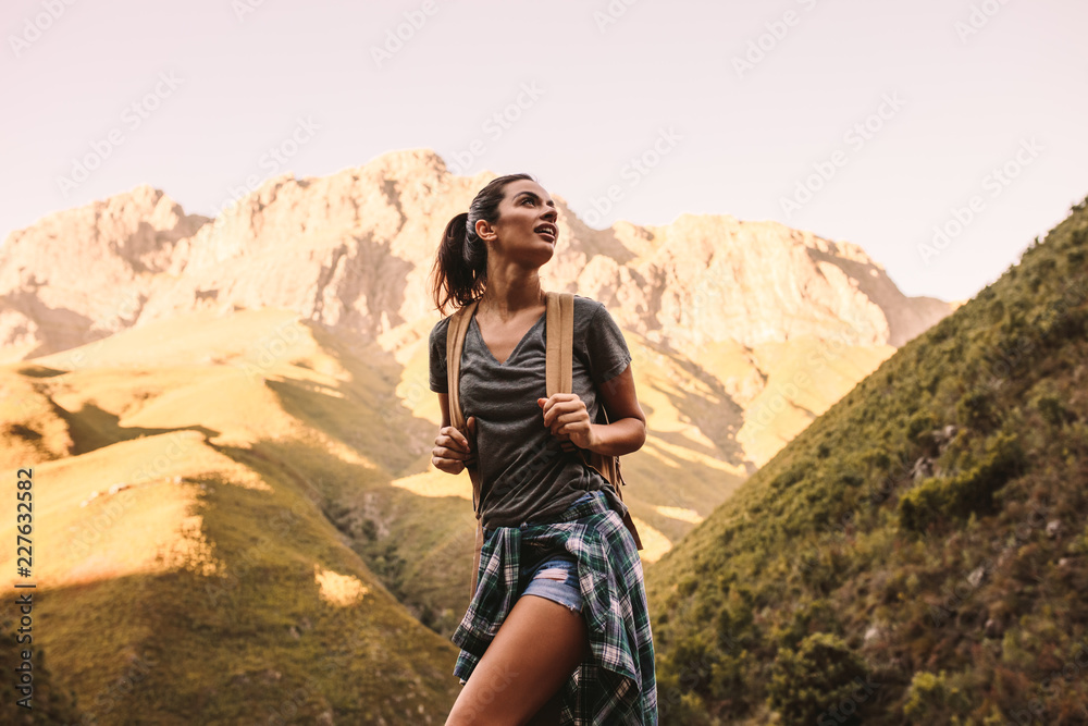 Woman hiking in mountains and looking at the scenic view Woman hiking in mountains and looking at the scenic view