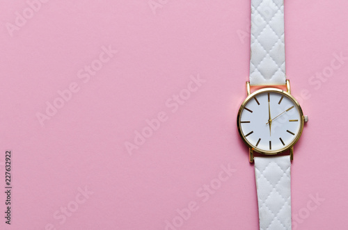 White watch on pink background