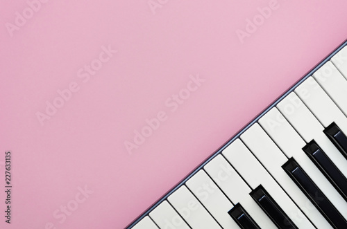 Pink music background with a piano  in the right corner