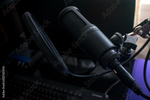 Closeup Black Microphone in home  recording studio with pop shield on mic stand
