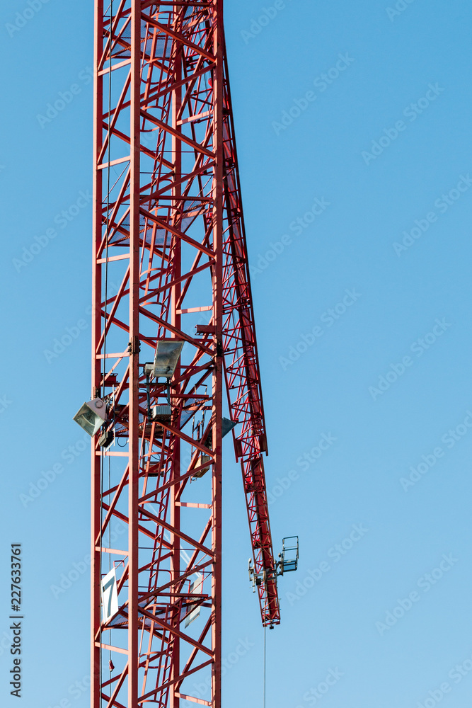 Red construction crane in front of blue sky Red construction crane in front of blue sky