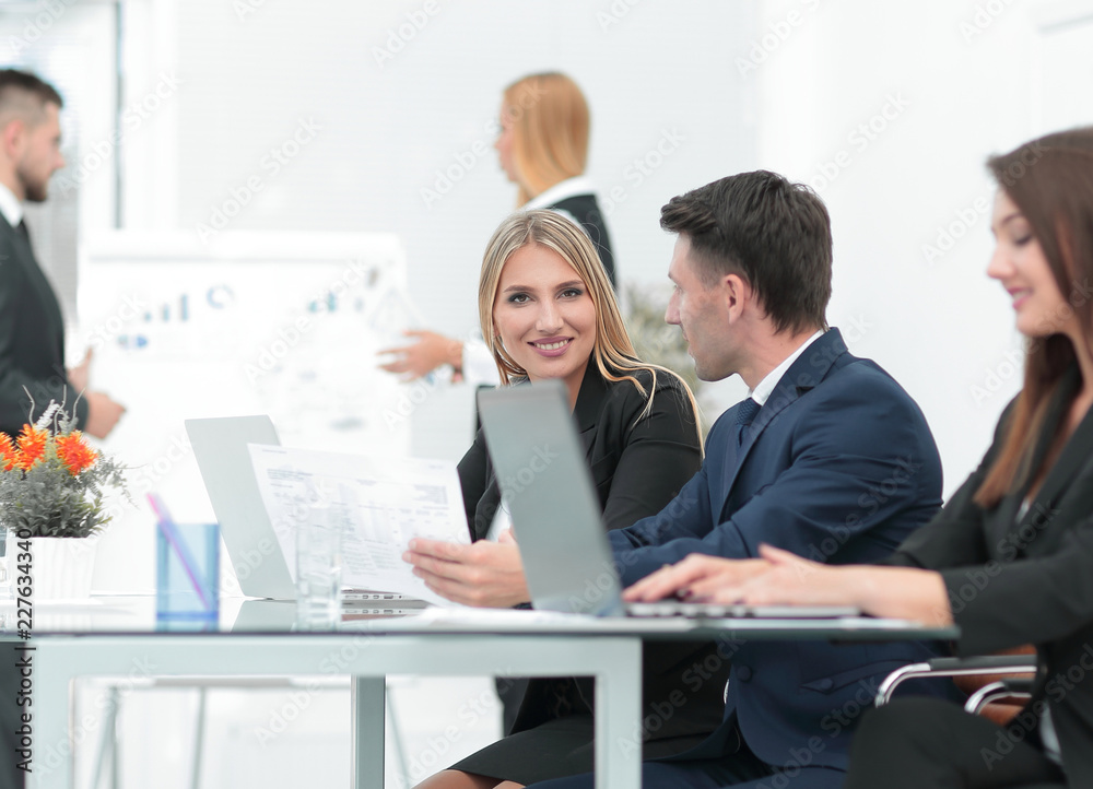 business team discussing new information , standing in front of the open laptop business team discussing new information , standing in front of the open laptop