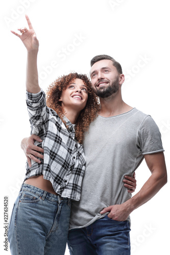 oung couple looking up and pointing upwards