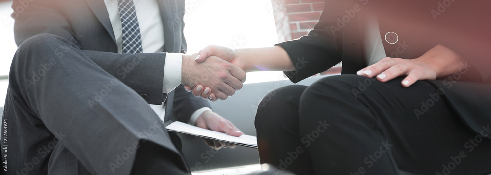 Close-up of two business people shaking hands