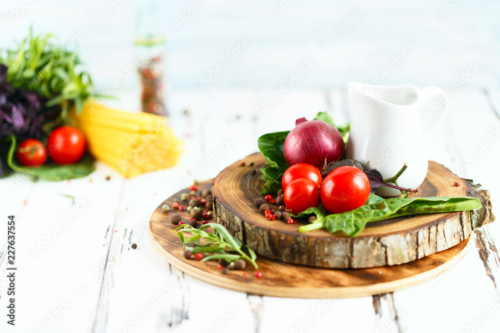 Cherry, tarragon, spaghetti, chili pepper, basil, spices Ingredients for cooking pasta. Food background on a white table Cherry, tarragon, spaghetti, chili pepper, basil, spices Ingredients for cooking pasta. Food background on a white table