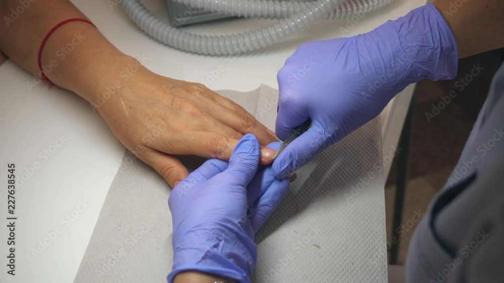 Cutting off the nails By nail scissors in professional nail salon. Beautiful female nails and manicure. Cutting off the nails By nail scissors in professional nail salon. Beautiful female nails and manicure.