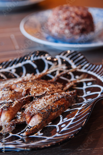 Thai food on dinner table, deep fried crispy makerel fish on beautiful plate photo