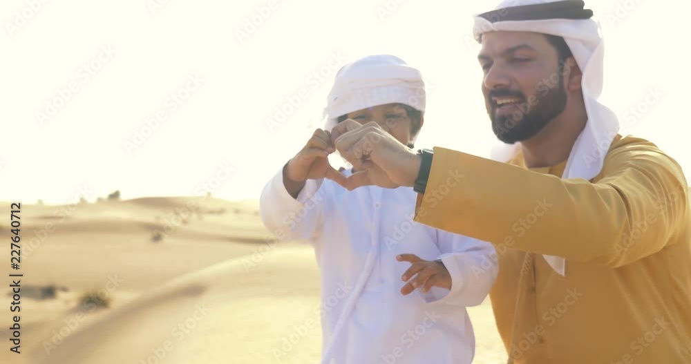 Father and son playing in the desert