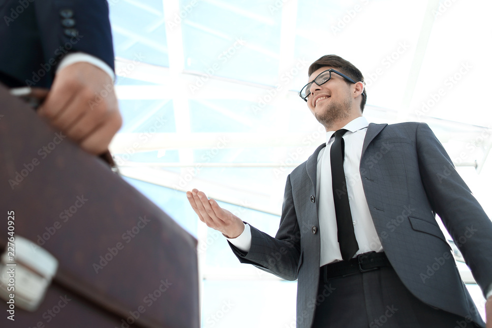 Detail of a businessman holding his briefcase Detail of a businessman holding his briefcase