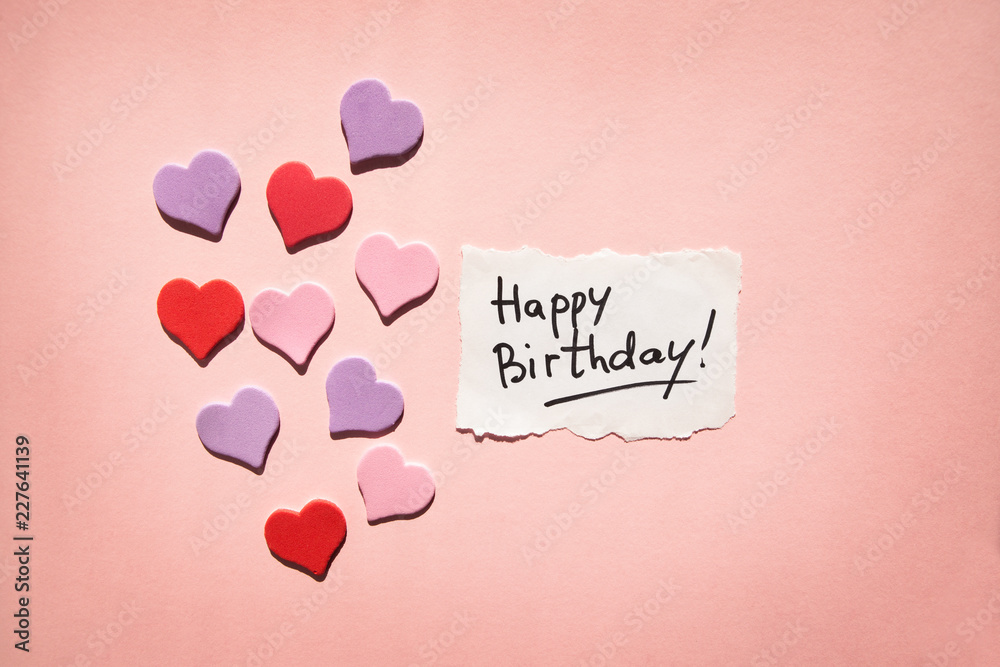 Happy birthday card with text and hearts on beautiful pink background