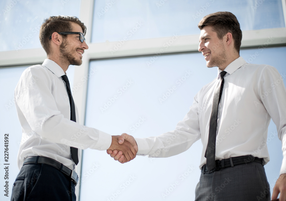 Closeup of business people shaking hands over a deal Closeup of business people shaking hands over a deal