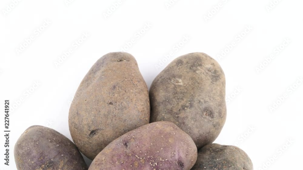 Half frame of violet potatoes. Slowly rotating on the turntable isolated on the white background. Close up. Macro. Copy space. Half frame of violet potatoes. Slowly rotating on the turntable isolated on the white background. Close up. Macro. Copy space.