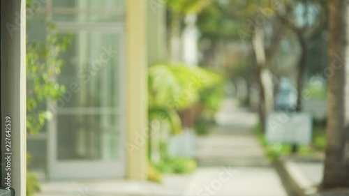 Blurred view down sunny street with small office building