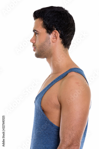 Profile view of young handsome Hispanic man