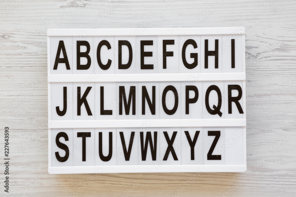 English alphabet on lightbox over white wooden background, overhead view. Letters from A to Z. Back to school concept. From above, flat lay, top view. English alphabet on lightbox over white wooden background, overhead view. Letters from A to Z. Back to school concept. From above, flat lay, top view.