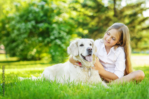 Teen  girl with golden retriever dog in the park © Natalia Chircova