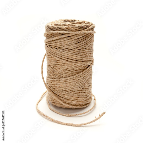 Spool of hemp string on a white background