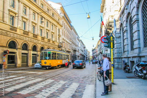 Tram and traffic on the old paved Streets of Milan