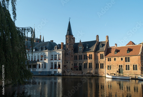 Old Bruges buildings reflecting in water canal in historical centre of Brugge © DigiHand