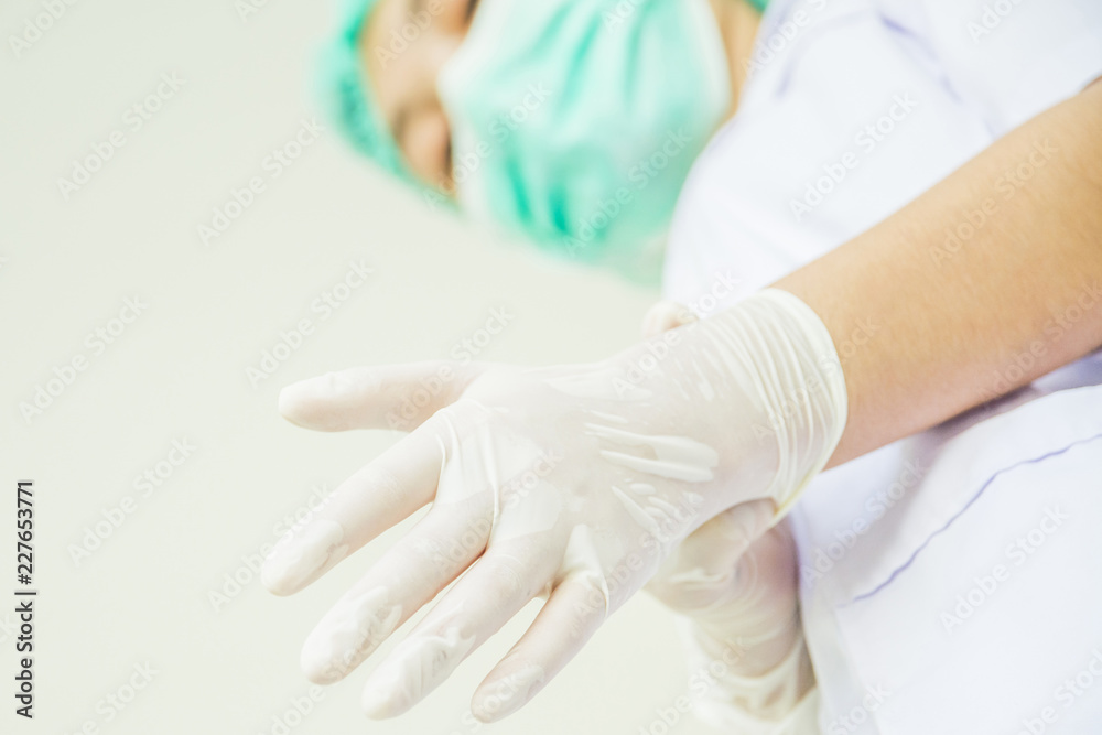 Doctor putting gloves Doctor putting gloves