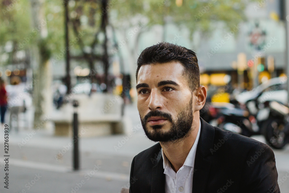 Worried arabic man sitting on the street. Space for text Worried arabic man sitting on the street. Space for text
