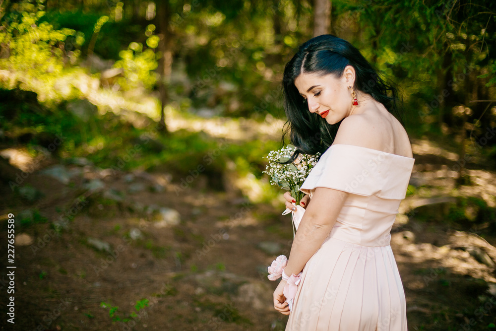 Portrait of beautiful and young bridesmaids with flowers outdoor. Two adorable girls embrace at forest park. Portrait of beautiful and young bridesmaids with flowers outdoor. Two adorable girls embrace at forest park.
