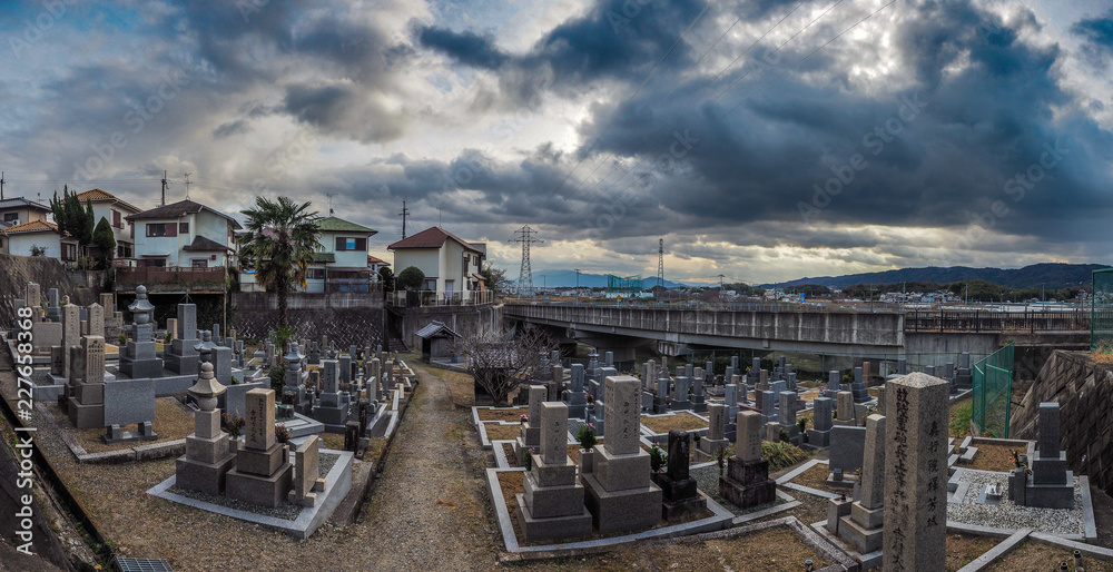 A cemetary in Japan with dark clouds