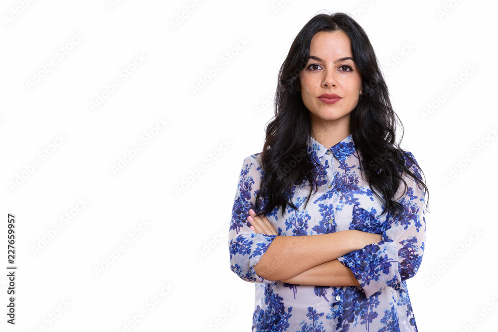 Studio shot of young beautiful Spanish businesswoman with arms c Studio shot of young beautiful Spanish businesswoman with arms c