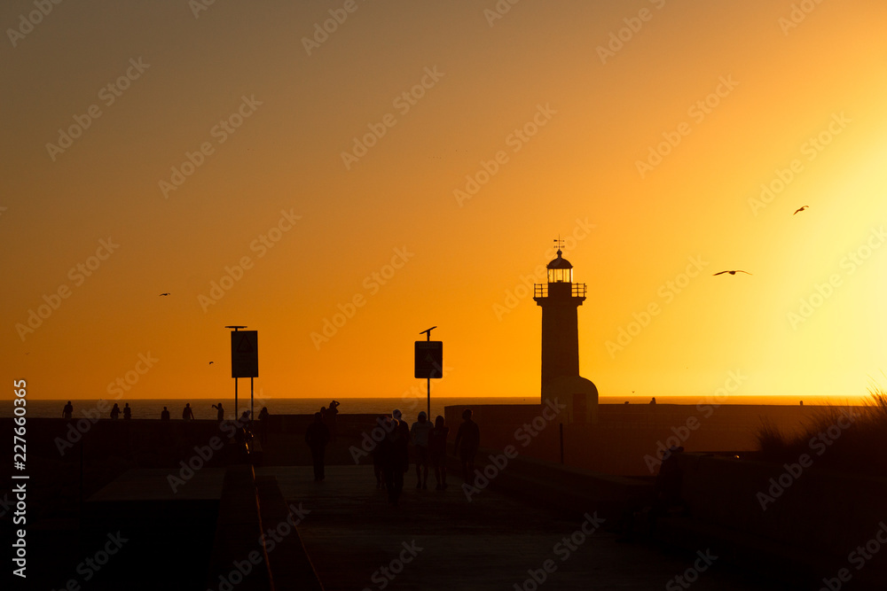 Farolim de Felgueiras and People Silhouettes at Dusk Farolim de Felgueiras and People Silhouettes at Dusk